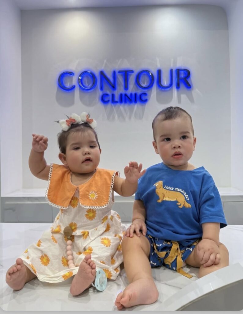 Dr. Bart Scanlon and wife Airada's twins sitting at Contour Clinic lobby